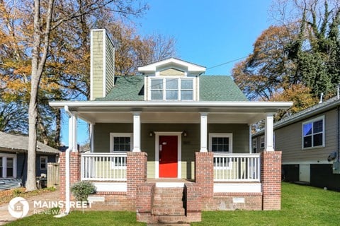 a house with a red door and a green roof